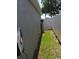Home's side yard shows some green grass, a fence, and a home utility structure at 10090 Se 67Th Ter, Belleview, FL 34420
