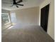 Spacious bedroom with plush carpet, ceiling fan, and closet provides a comfortable retreat at 13774 Meadowpark Ave, Orlando, FL 32826