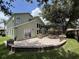 A wide view of the home exterior, including the spacious patio with a custom fire pit and pergola at 13774 Meadowpark Ave, Orlando, FL 32826