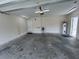 Spacious garage featuring a utility sink and a water heater; door leading to inside the house at 13774 Meadowpark Ave, Orlando, FL 32826