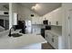 Bright kitchen featuring white cabinetry, modern black appliances, and granite countertops at 13774 Meadowpark Ave, Orlando, FL 32826