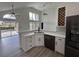 Bright kitchen with white cabinets, stainless steel appliances, and a breakfast bar at 13774 Meadowpark Ave, Orlando, FL 32826