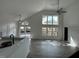 Bright living room with vaulted ceiling, ceiling fan, and patio access features an open floor plan at 13774 Meadowpark Ave, Orlando, FL 32826