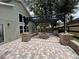 Outdoor patio with a fire pit and brick hardscaping offers a relaxing entertainment space at 13774 Meadowpark Ave, Orlando, FL 32826