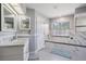 Elegant bathroom with marble accents, a soaking tub, and double vanity at 2925 Deerbrook Dr, Lakeland, FL 33811