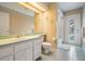 Well-lit bathroom with a functional vanity, toilet, and shower-tub combo, offering convenience and practicality at 2925 Deerbrook Dr, Lakeland, FL 33811