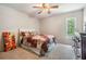 Comfortable bedroom with carpet, complemented by natural light and a ceiling fan for added comfort at 2925 Deerbrook Dr, Lakeland, FL 33811