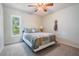 Bright bedroom featuring a ceiling fan and a large window, offering natural light and a relaxing space at 2925 Deerbrook Dr, Lakeland, FL 33811
