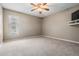 Cozy bedroom with neutral walls, carpeted floors, and a ceiling fan, offering a relaxing atmosphere at 2925 Deerbrook Dr, Lakeland, FL 33811