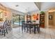 Bright dining area features an oval table with black chairs, white tiled flooring, and backyard pool view at 2925 Deerbrook Dr, Lakeland, FL 33811