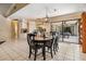 Bright dining area features an oval table with black chairs, white tiled flooring, and backyard view at 2925 Deerbrook Dr, Lakeland, FL 33811