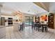 Bright dining area features an oval table with black chairs, white tiled flooring, and backyard pool view at 2925 Deerbrook Dr, Lakeland, FL 33811