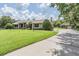 Sprawling single story home with lush green lawn, mature trees and separate garage at 2925 Deerbrook Dr, Lakeland, FL 33811