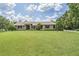 Well-maintained front lawn, with mature trees and shrubs, complementing this charming single-story home at 2925 Deerbrook Dr, Lakeland, FL 33811