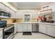 Bright kitchen with white cabinetry, stainless steel appliances and tile floors at 2925 Deerbrook Dr, Lakeland, FL 33811