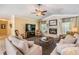 Spacious living room with plush sofas, a fireplace, ceiling fan, and neutral decor at 2925 Deerbrook Dr, Lakeland, FL 33811