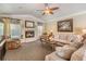 Cozy living room with a fireplace, plush sofas, and natural lighting at 2925 Deerbrook Dr, Lakeland, FL 33811