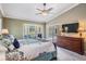 Bright main bedroom with a bay window, ceiling fan, and access to outdoor pool at 2925 Deerbrook Dr, Lakeland, FL 33811