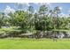 Scenic view of the pond, enhanced with lily pads and bordering the grassy lawn at 2925 Deerbrook Dr, Lakeland, FL 33811