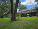 Large backyard view featuring a screened-in patio and green space for outdoor enjoyment at 909 Heatherbrook Dr, Auburndale, FL 33823