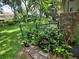 Landscaped backyard featuring lush greenery, plants, and a partial view of the home at 909 Heatherbrook Dr, Auburndale, FL 33823