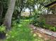 Green backyard featuring a chain-link fence, a manicured lawn, and attractive landscaping details at 909 Heatherbrook Dr, Auburndale, FL 33823