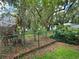 Secluded backyard with chain link fence and lush greenery offering a private outdoor space at 909 Heatherbrook Dr, Auburndale, FL 33823