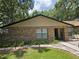 Charming single-Gathering home featuring a brick facade, manicured lawn, and welcoming entrance at 909 Heatherbrook Dr, Auburndale, FL 33823