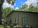 Exterior view of the home highlighting the siding, windows, and outdoor space at 909 Heatherbrook Dr, Auburndale, FL 33823