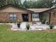 Inviting front entrance featuring a covered porch, landscaped garden beds, and a well-manicured lawn at 909 Heatherbrook Dr, Auburndale, FL 33823