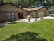 Well-maintained front yard with lush green lawn, landscaping, and a charming home exterior at 909 Heatherbrook Dr, Auburndale, FL 33823