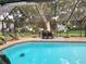 Inviting screened-in pool area with outdoor seating, perfect for relaxing and entertaining in style at 909 Heatherbrook Dr, Auburndale, FL 33823