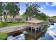 Aerial view of home highlighting its location on a canal with a covered dock at 93 Bream St, Haines City, FL 33844