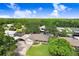 Aerial view of a home with lush greenery, a long driveway, and close proximity to the water at 93 Bream St, Haines City, FL 33844