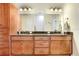 Bathroom features double sink vanity, wood cabinets, granite countertops, and shower-tub combination at 93 Bream St, Haines City, FL 33844