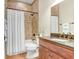 Bathroom with shower-tub combination, neutral tile, vanity with a granite top, and matching cabinets at 93 Bream St, Haines City, FL 33844