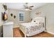 Bedroom features hardwood floors, a ceiling fan, a full bed, and a dresser at 93 Bream St, Haines City, FL 33844