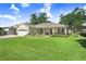 Inviting one-story home with a spacious green lawn, attached garage, and covered entrance at 93 Bream St, Haines City, FL 33844