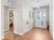 Bright foyer with wood floors, stylish lighting, and easy access to other rooms in this beautifully maintained home at 93 Bream St, Haines City, FL 33844