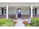 Inviting front porch with decorative accents, colorful flowers, and a charming welcome sign enhances curb appeal at 93 Bream St, Haines City, FL 33844