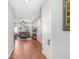 Inviting hallway with wood flooring leading to a comfortable living room, enhancing the flow of the home at 93 Bream St, Haines City, FL 33844