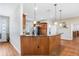 Kitchen bar with wood front, granite countertop, pendant lights, and hardwood floors at 93 Bream St, Haines City, FL 33844