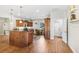 Open-concept kitchen with wooden cabinetry, modern appliances, and a breakfast bar, perfect for casual dining at 93 Bream St, Haines City, FL 33844
