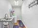 Bright laundry room with sink, gray cabinets, granite countertops, washer and dryer, and ample storage at 93 Bream St, Haines City, FL 33844