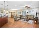 Spacious living room with hardwood floors, ceiling fan, and large windows providing ample natural light at 93 Bream St, Haines City, FL 33844