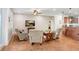 Comfortable living room with a ceiling fan, wood flooring, and a TV, ideal for relaxation and entertainment at 93 Bream St, Haines City, FL 33844