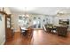 Open-concept living and dining area features hardwood floors, recessed lighting, and sliding glass doors to the patio at 93 Bream St, Haines City, FL 33844