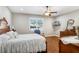 Relaxing main bedroom features wood floors, a ceiling fan, and a large window with plantation shutters at 93 Bream St, Haines City, FL 33844