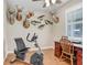 Office with desk, exercise bike, mounted fish and deer, hardwood floor, and window at 93 Bream St, Haines City, FL 33844