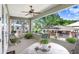 Cozy covered patio with ceiling fan, potted plants, and outdoor furniture for relaxing at 93 Bream St, Haines City, FL 33844